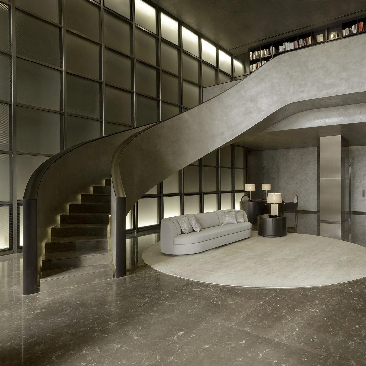Living space with a curved staircase and a wall of shelving