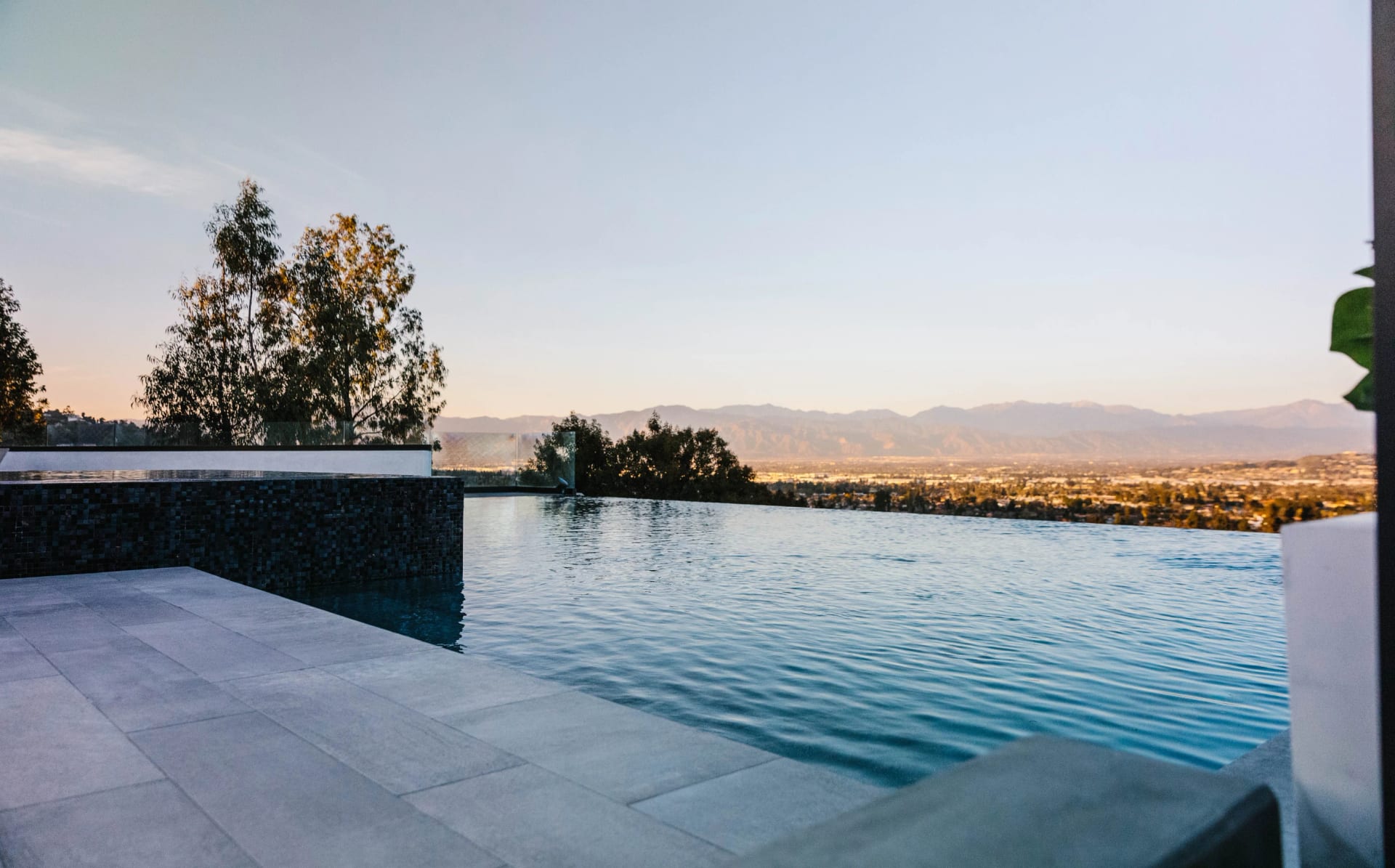 Infinity pool overlooking a valley with mountains in the distance