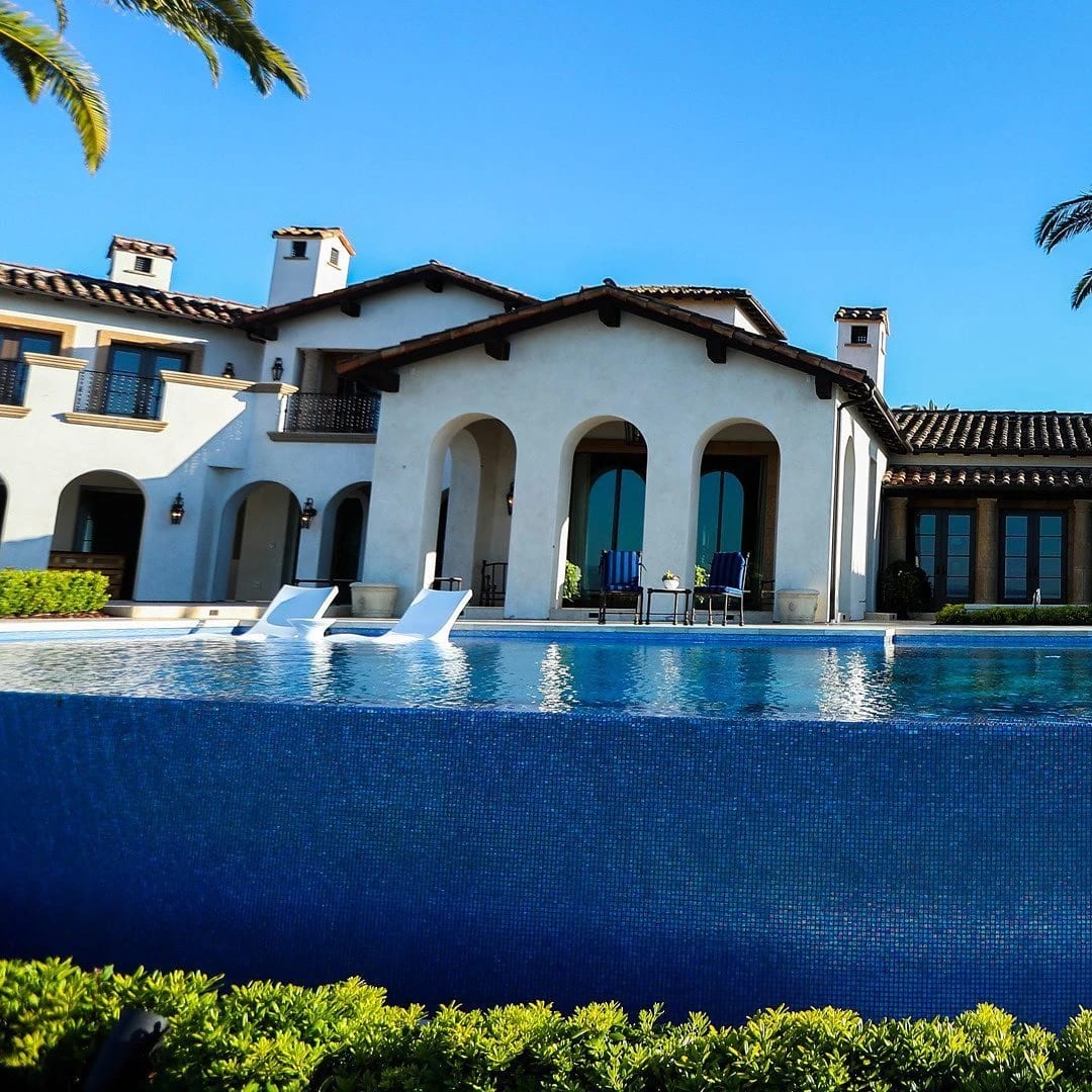 Mediterranean villa with arched windows and an infinity pool